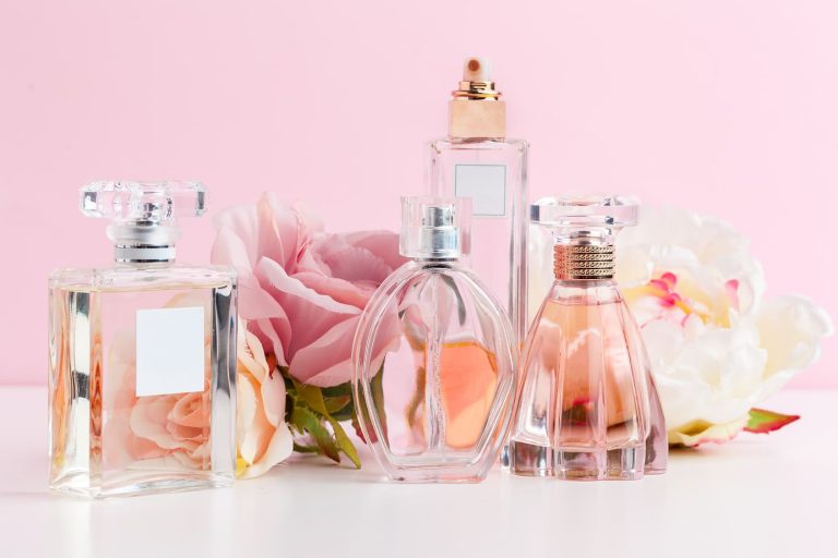 bottle-of-perfume-with-flowers-on-color-background-2025-02-24-20-40-04-utc 1 1