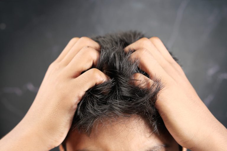 teenage-boy-scratching-head-against-black-backgrou-2024-12-10-04-13-04-utc 1