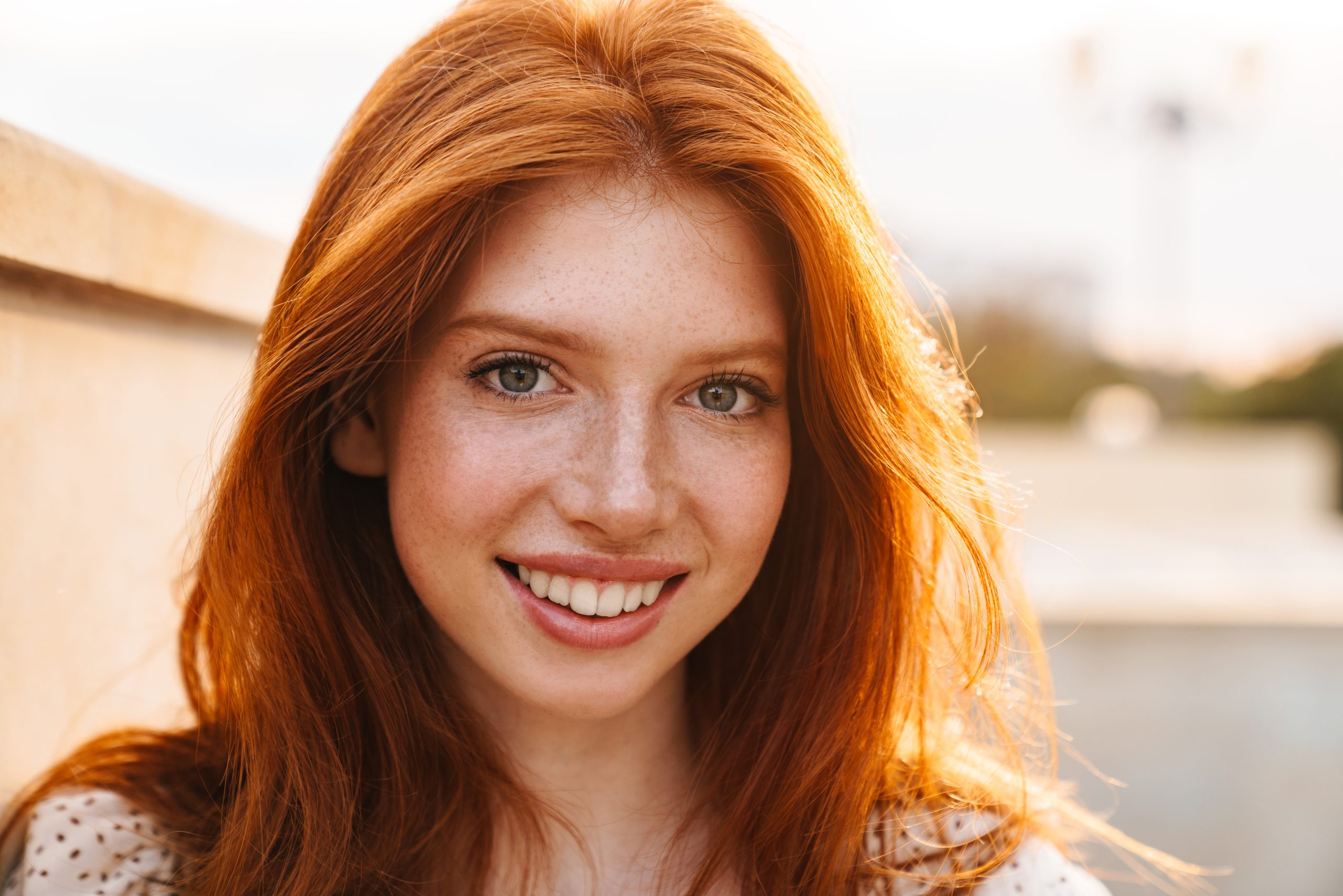 Image of cheerful ginger girl smiling and looking at camera Image of cheerful ginger girl smiling and looking at camera